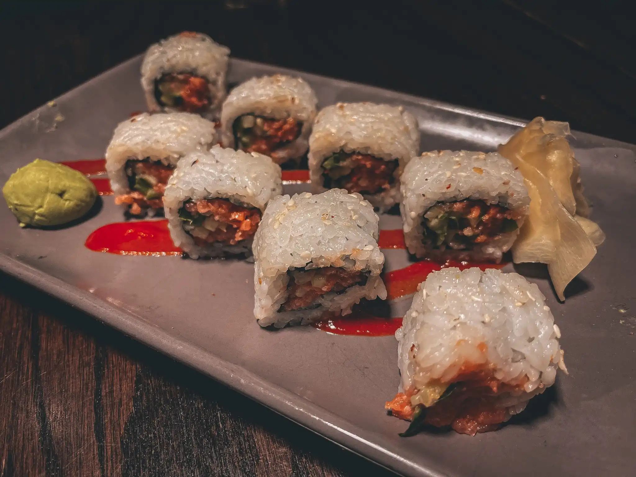 Plate of sushi rolls with wasabi and ginger